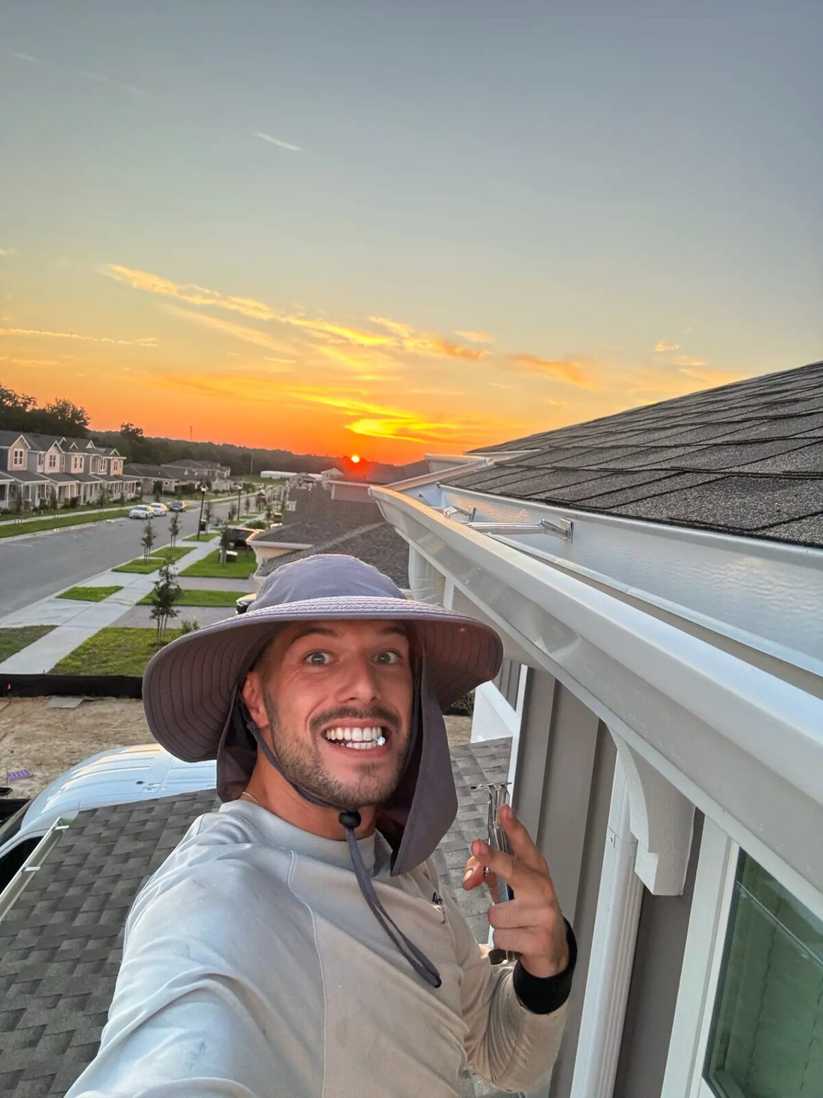 White seamless gutters and downspouts finished along the rooflines of a two-story Florida home